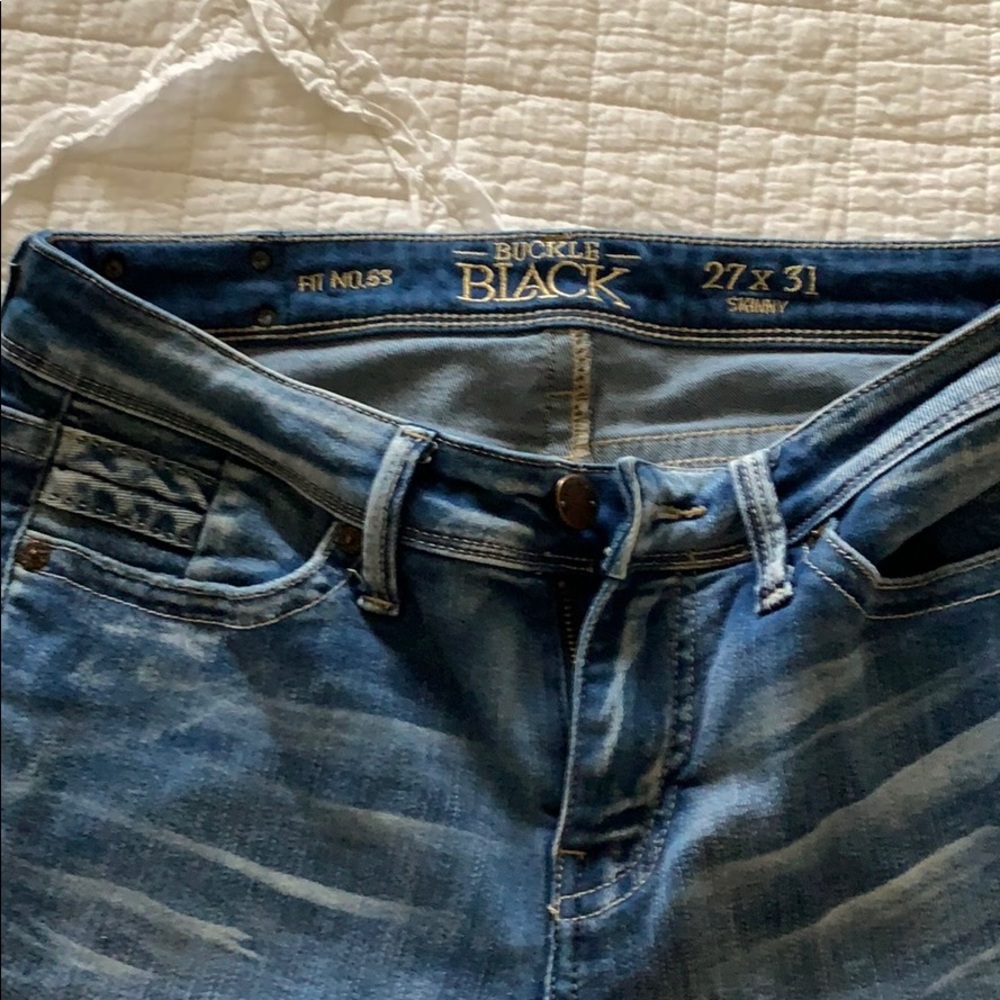 Buckle black skinny jeans